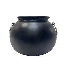 a large black vase sitting on top of a white surface