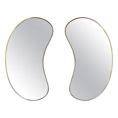 a pair of oval mirrors sitting next to each other