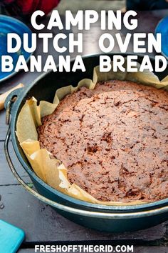 a close up of a cake in a pan with the words camping dutch oven banana bread