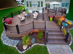 a deck with chairs and plants on it