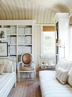 a living room filled with furniture and bookshelves