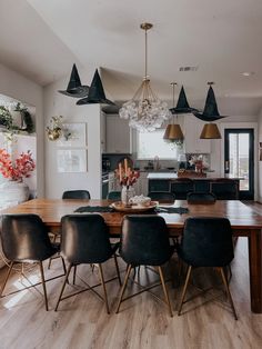 a dining room table surrounded by black chairs