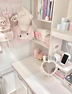 a white desk topped with lots of stuffed animals on top of it's shelves