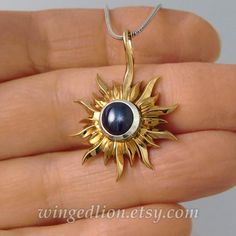 The SOLAR ECLIPSE pendant made in bronze and sterling silver with a lab-created Star Sapphire round cabochon (7mm). The pendant is about 24mm in diameter (the size of the 25 cents US coin) plus the bail.The pendant is made to order - please allow time for production.A chain is not included with the pendant. We have suitable silver chain in various lengths:www.etsy.com/listing/257772054/Here is a matching SUN and MOON ring set:www.etsy.com/listing/183946247/The current listing is for the pendant Unique Round Jewelry With Sun Design, Unique Round Sun Design Jewelry, Celestial Jewelry With Sun Design Round Pendant, Celestial Sun Design Round Pendant Jewelry, Silver Sunburst Jewelry For Gifts, Silver Brass Jewelry With Shiny Finish, Silver Jewelry In Brass With Shiny Finish, Silver Celestial Jewelry With Cabochon, Celestial Silver Jewelry With Cabochon