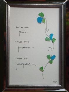 a frame with some writing on it and flowers in the middle, as well as two butterflies