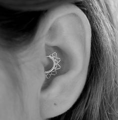 a woman's ear with an intricate design on it