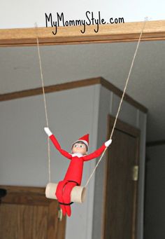 an elf hanging from a rope on the ceiling