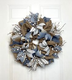 a blue and white wreath hanging on the front door