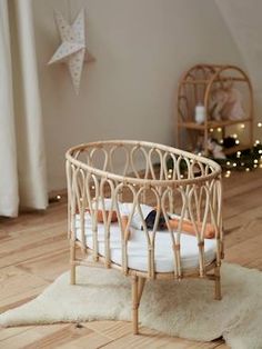 a baby's crib in the corner of a room with white rugs