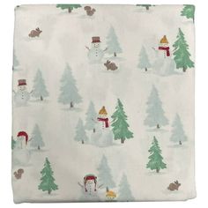 a white fabric with snowmen and trees on it