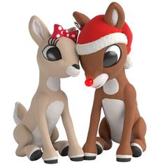 two toy deers sitting next to each other wearing santa's hats on their heads