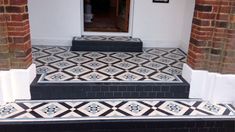 black and white tiled steps leading up to a door