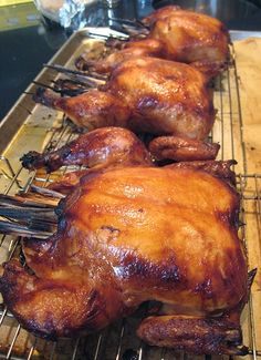 there are several pieces of cooked chicken on the rack, ready to be grilled