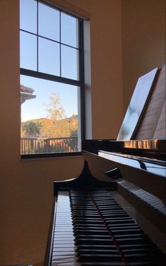 a piano sitting in front of a window