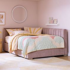 a bedroom with pink walls and a bed in the middle is decorated with pastel colors