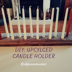 candles are lined up in front of a fireplace with the words diy occupied candle holder