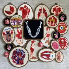 an assortment of hand embroidered items displayed on a table