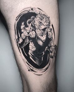 a man's leg with a black and white tattoo on it