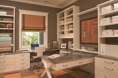 a home office with lots of white cabinets and drawers on the wall, along with an orange checkered floor