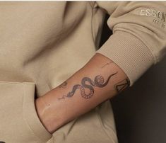 a person with a snake tattoo on their arm