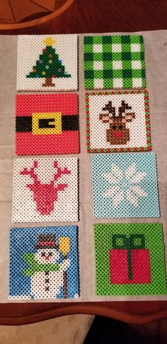 cross stitch christmas coasters on a table