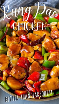 a pan filled with chicken and peppers on top of a table next to a fork