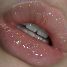 a close up view of a person's lip with glitter on it