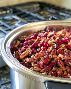 a cranberry sauce in a slow cooker with pecans