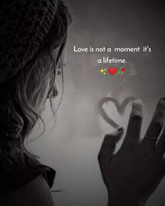 a woman holding a heart in her hand with the words love is not a moment it's a lifetime