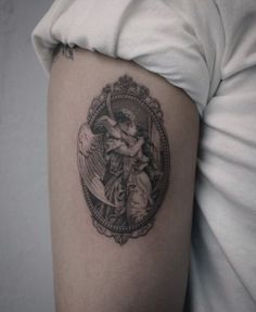 a woman's arm with an angel tattoo on the left side of her body