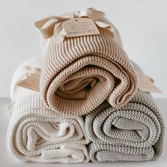 several folded blankets stacked on top of each other