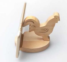 a wooden toy with a chicken on it