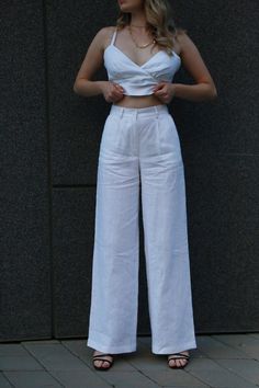 White linen palazzo pants are the epitome of style and comfort, perfect for the warmer seasons. Cut: These pants have a wide, loose cut that allows for maximum freedom of movement and impressive lightness. From the hips to the bottom, the trousers gradually widen, creating an elegant silhouette that emphasizes the slenderness of the figure. Material: Made from high-quality linen, these pants are not only breathable, but also have a nice texture for all-day comfort. Flax also gives the product a natural shine that adds elegance to it. Details: White palazzo pants are easy to match with a variety of tops, from classic blouses and tops to loose t-shirts. They have delicate side pockets that add convenience when wearing. Style: These pants are great for a variety of occasions, from casual outi High Waist Fitted Wide Leg Linen Pants, Fitted High Waist Linen Wide Leg Pants, White Linen Wide Leg Pants, Fitted Wide Leg Linen Pants, Elegant Wide Leg Linen Bottoms, High Waist Linen Wide Leg Pants, Wide-leg Linen Pants, Chic White Linen Pants, Elegant Wide Leg Linen Pants