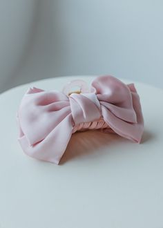 Say goodbye to fussy bows and hello to effortless style with this must-have accessory. The SATIN BOW HAIR CLAW in ballerina pink adds sophisticated allure to any hairstyle without the hassle of tying bows. A perfect addition to your hair routine for a touch of glamour and convenience. Dimensions: Long: 5" | Wide: 2" Shipping Free standard shipping on all orders of $150 or more! Free In-store Pick-up- This is a wonderful option if you live in the area! Orders are typically processed within a couple of hours during business hours. If an order is placed after business hours or during holiday hours, the order will be fulfilled during the next business day. You will receive an email notification letting you know when your order is ready for pickup. USPS Priority Mail-Transit time is 1-5 busines Tying Bows, Email Notification, Ballerina Pink, Holiday Hours, Pink Ballerina, Hair Routine, Denim Gift, Hair Routines, Bow Hair