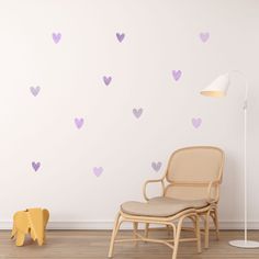 a chair sitting in front of a white wall with purple heart decals on it