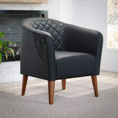 a black leather chair sitting on top of a carpeted floor next to a fireplace