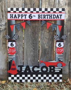 a wooden sign that says happy 6th birthday with a race car on the front and number six