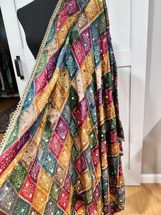 Experience the beauty of traditional Phulkari style with our Multicolor Dupatta. Made with a soft and luxurious silk finish, this dupatta features real mirror accents and stunning designs. Its heavy-weight construction makes it perfect for special occasions like Navaratri. Elevate your wardrobe with this must-have accessory. Approx 2.5 meters length Anarkali Style Multicolor Lehenga With Mirror Work, Anarkali Lehenga With Multicolor Mirror Work, Traditional Draped Lehenga With Mirror Work In Jamawar, Semi-stitched Multicolor Lehenga With Sheer Dupatta, Multicolor Chanderi Lehenga With Zari Work, Multicolor Art Silk Anarkali Set With Traditional Drape, Anarkali Traditional Wear With Multicolor Mirror Work, Jamawar Sharara With Dupatta In Traditional Drape, Bollywood Anarkali Set With Multicolor Embroidery And Mirror Work