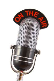 an old fashioned microphone with the words on the air written in red and black lettering