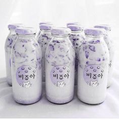 six jars with purple and white designs on them