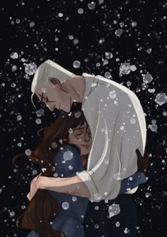 a man and woman hugging in the snow with falling snowflakes around them on a black background