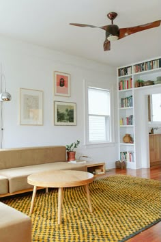 a living room filled with furniture and bookshelves