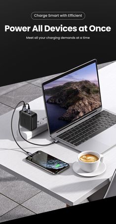 an open laptop computer sitting on top of a table next to a cup of coffee