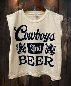 Cowboys and Beer Boxy Cropped midriff muscle top 6 oz./yd², 100% cotton, garment-dyed, 18 singles Garment-dyed for that vintage, faded look and almost no shrinkage at home Boxy fit, slightly cropped Wide rib collar Taped neck and shoulders for comfort and durability Structured shoulders Body Length    20    21    22    23    24 Body Length Tolerance    +/-1    +/-1    +/-1    +/-1    +/-1 Chest Tolerance    +/-1    +/-1    +/-1    +/-1    +/-1 Chest Width (Laid Flat)    21    22    23    24 1/2    26 Cowboy Apparel Men, Concert Outfit Country, Western Graphic Tees, Beer Logo, Baby Crop Top, Distressed Tee, Sweatshirt Short Sleeve, Beer Shirts, Crew Sweatshirts