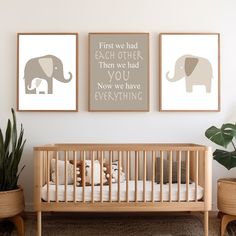 two framed pictures hang on the wall above a crib in a baby's room