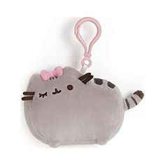 a stuffed animal with a pink bow on it's head is hanging from a key chain