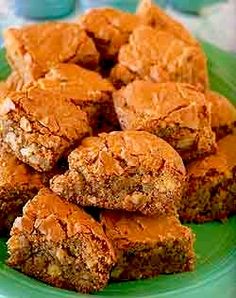 a green plate topped with brownies covered in peanut butter