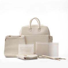 a white bag, wallet, and other items are arranged on a white table top