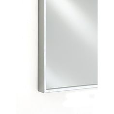 a bathroom mirror mounted to the side of a wall