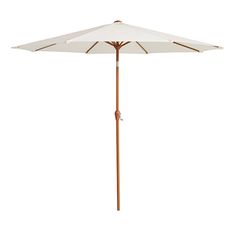 an umbrella that is open and sitting on a white surface with wood trimmings